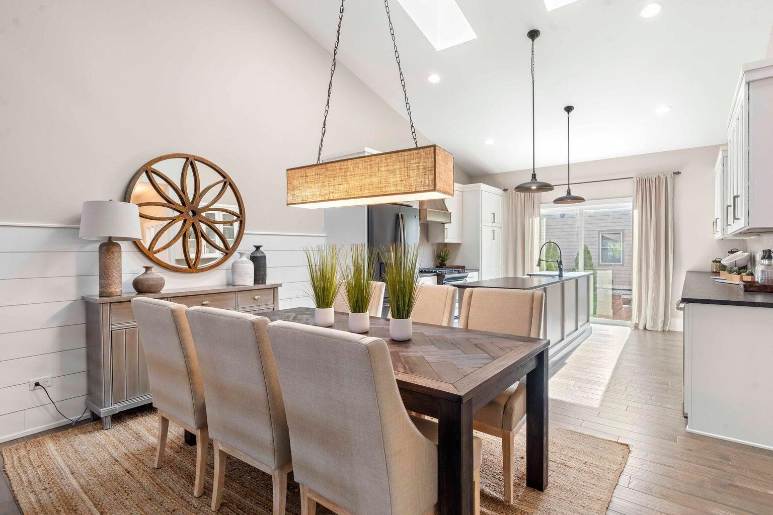 10883 Walnut Drive St. John, IN 46373 - Photo 6 of 30 a dining room with furniture a chandelier and wooden floor