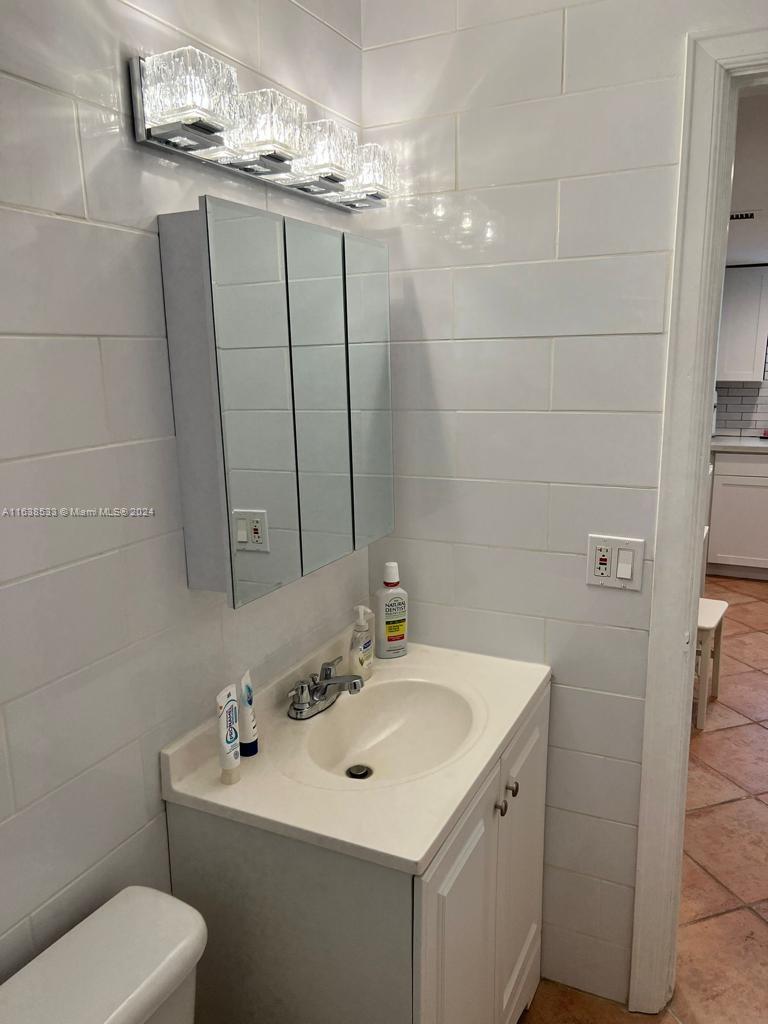 820 3rd Street, Unit 3 Miami Beach, FL 33139 - Photo 11 of 24 a bathroom with a sink toilet and vanity