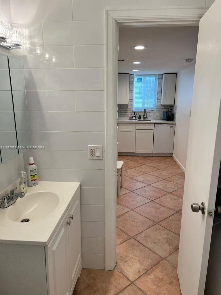 820 3rd Street, Unit 3 Miami Beach, FL 33139 - Photo 12 of 24 a bathroom with a sink a mirror and a shower