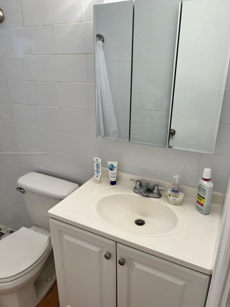 820 3rd Street, Unit 3 Miami Beach, FL 33139 - Photo 15 of 24 a bathroom with a sink and a toilet