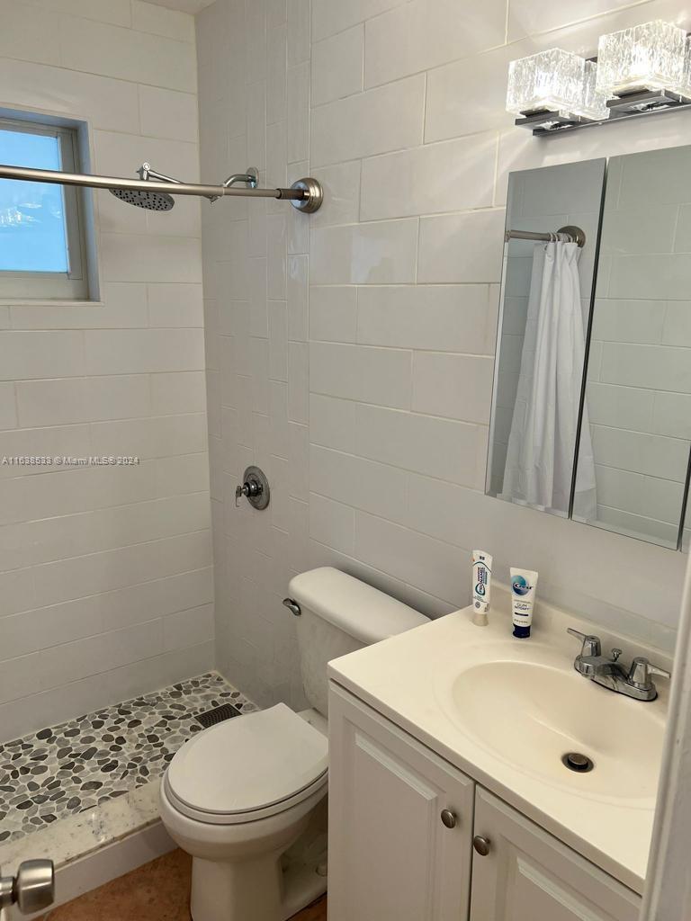 820 3rd Street, Unit 3 Miami Beach, FL 33139 - Photo 16 of 24 a bathroom with a sink a toilet and shower