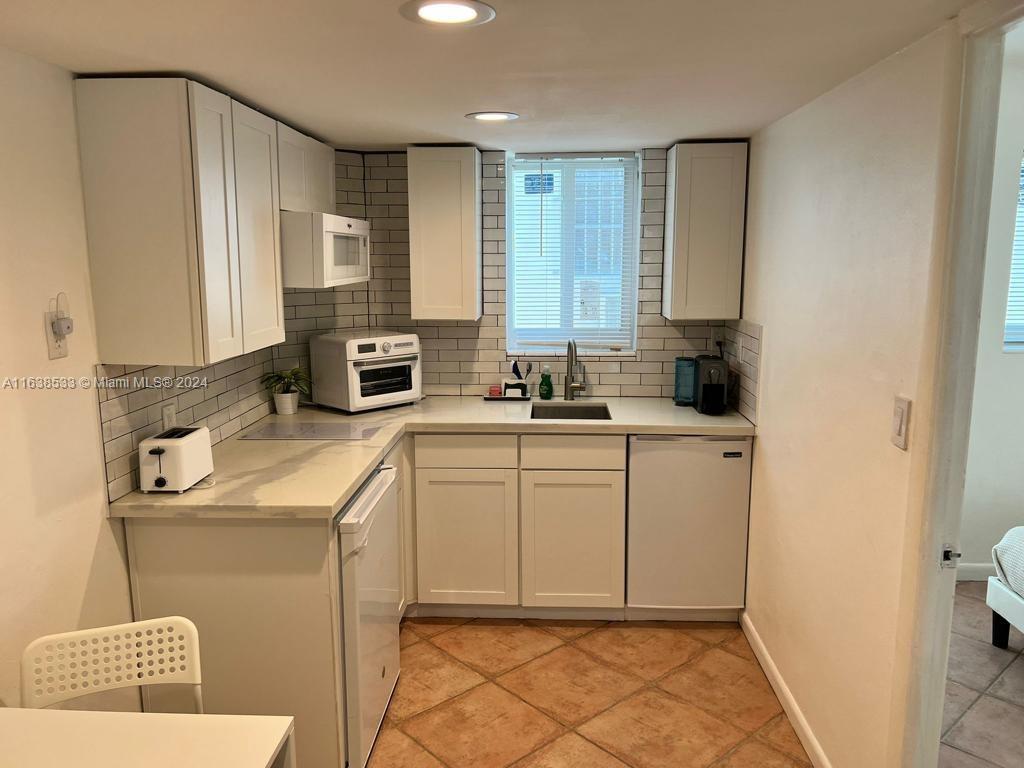 820 3rd Street, Unit 3 Miami Beach, FL 33139 - Photo 20 of 24 a kitchen with sink cabinets and window