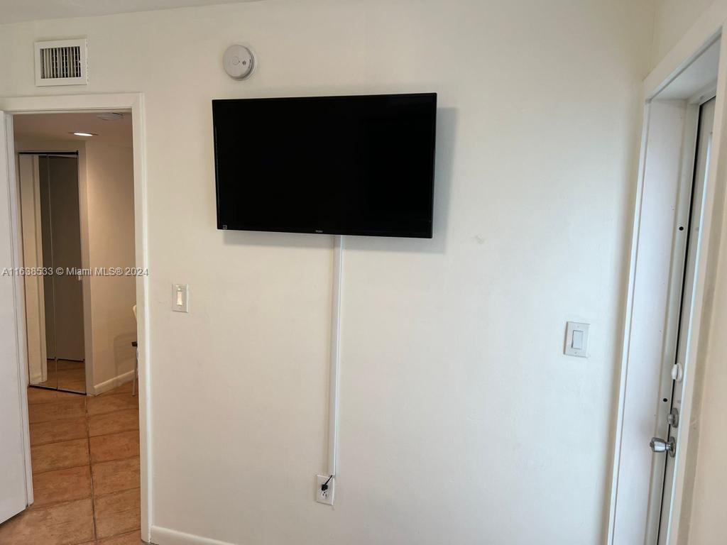 820 3rd Street, Unit 3 Miami Beach, FL 33139 - Photo 21 of 24 a living room with a flat screen tv and a door