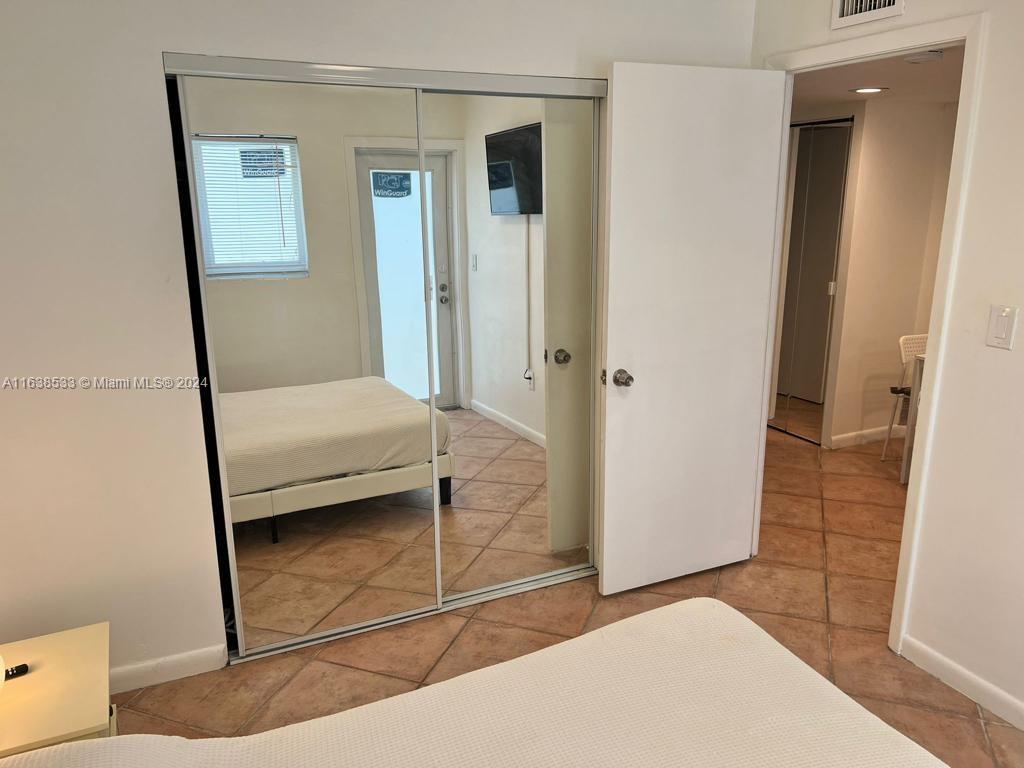 820 3rd Street, Unit 3 Miami Beach, FL 33139 - Photo 22 of 24 a bedroom with a bed and a shower