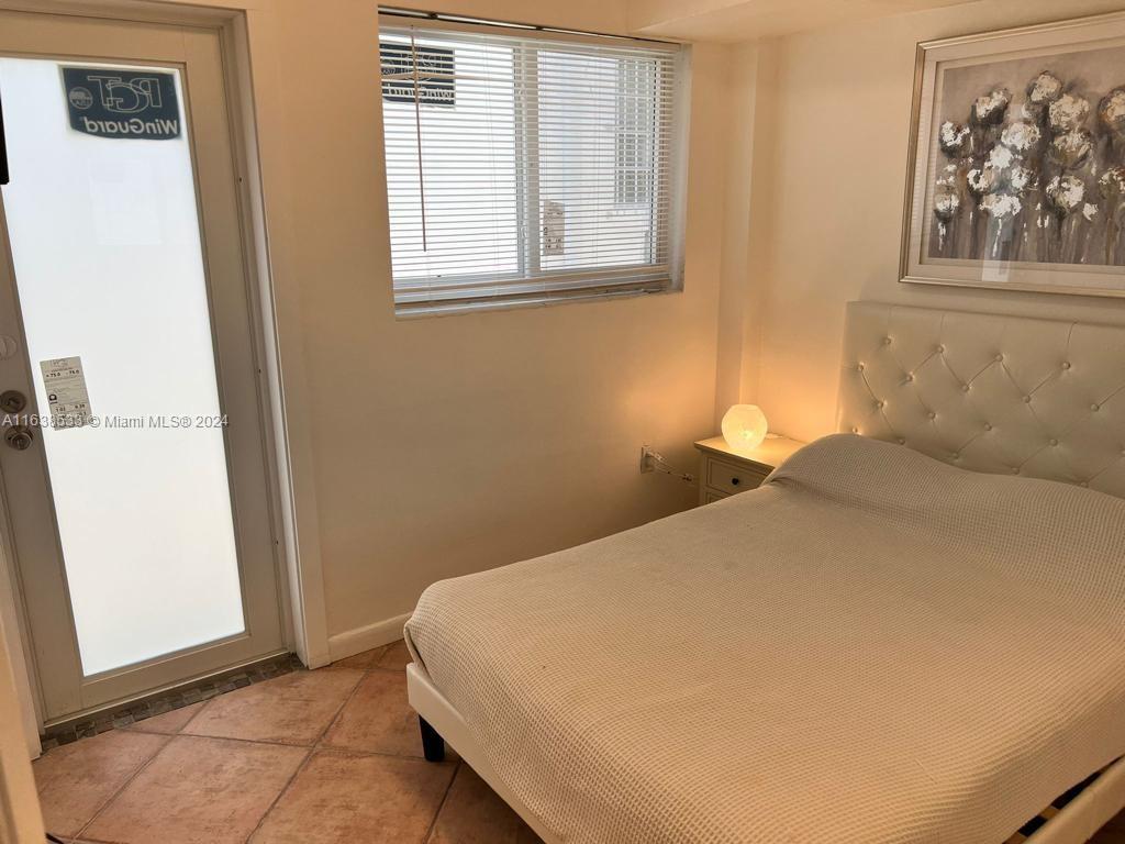 820 3rd Street, Unit 3 Miami Beach, FL 33139 - Photo 23 of 24 a bedroom with a bed and a window