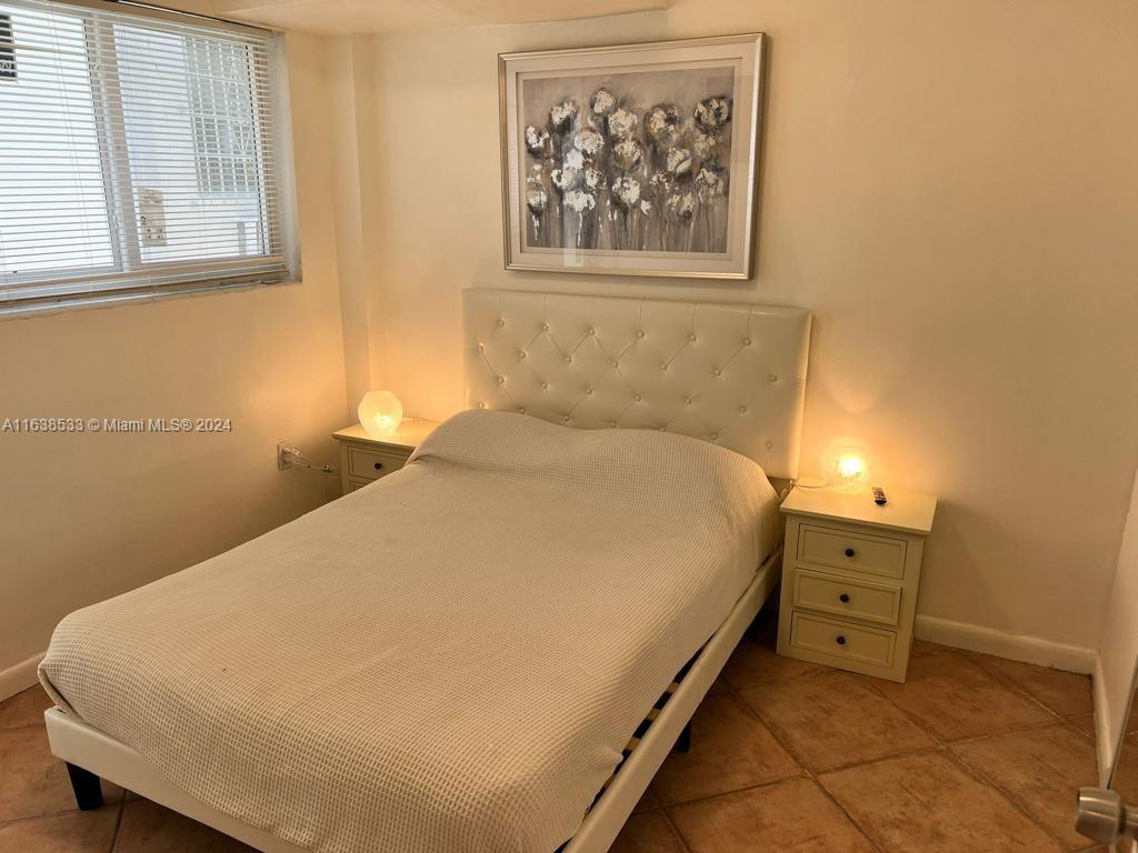 820 3rd Street, Unit 3 Miami Beach, FL 33139 - Photo 24 of 24 a bed sitting in a bedroom next to a window
