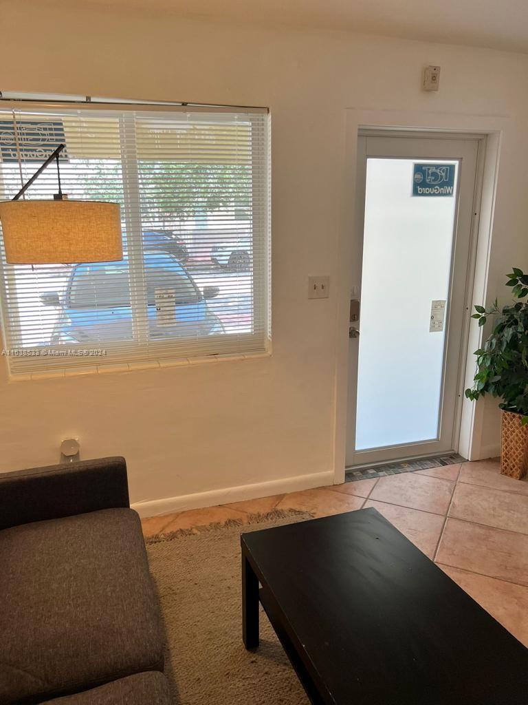 820 3rd Street, Unit 3 Miami Beach, FL 33139 - Photo 5 of 24 a living room with a bed furniture and a large window
