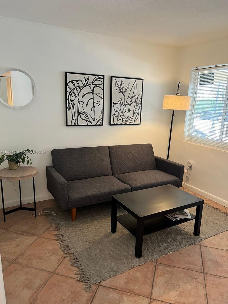 820 3rd Street, Unit 3 Miami Beach, FL 33139 - Photo 9 of 24 a living room with furniture and a table