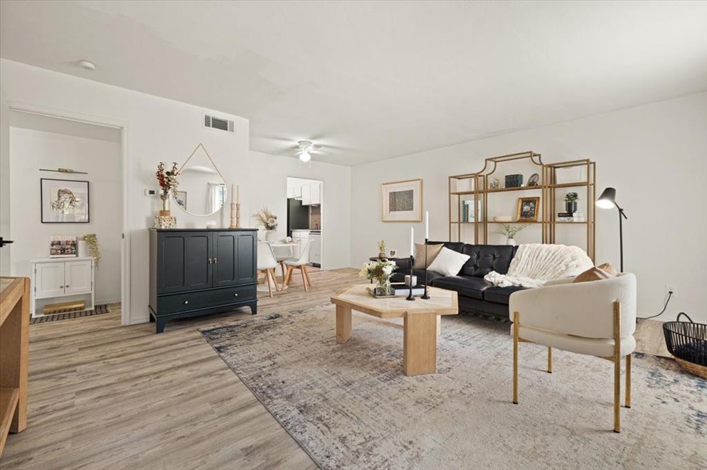 4100 Ridglea Country Club Drive, Unit 1401 Fort Worth, TX 76126 - Photo 2 of 27 a living room with furniture and a flat screen tv
