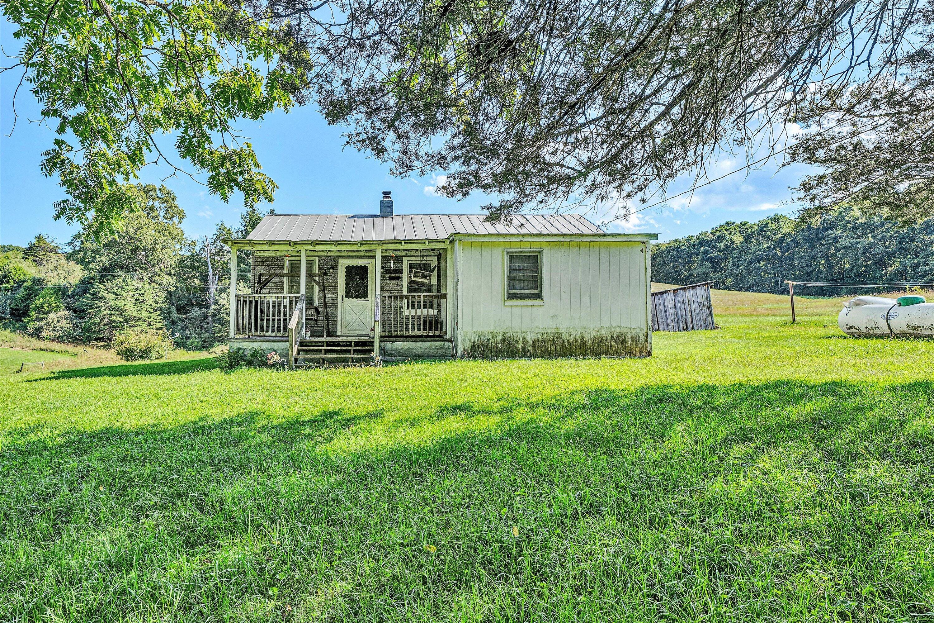 2816 Johns Creek Road New Castle, VA 24127 - Photo 12 of 40 a view of a house with backyard and a tree