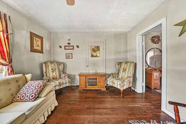 a view of an empty room with a fireplace and a window