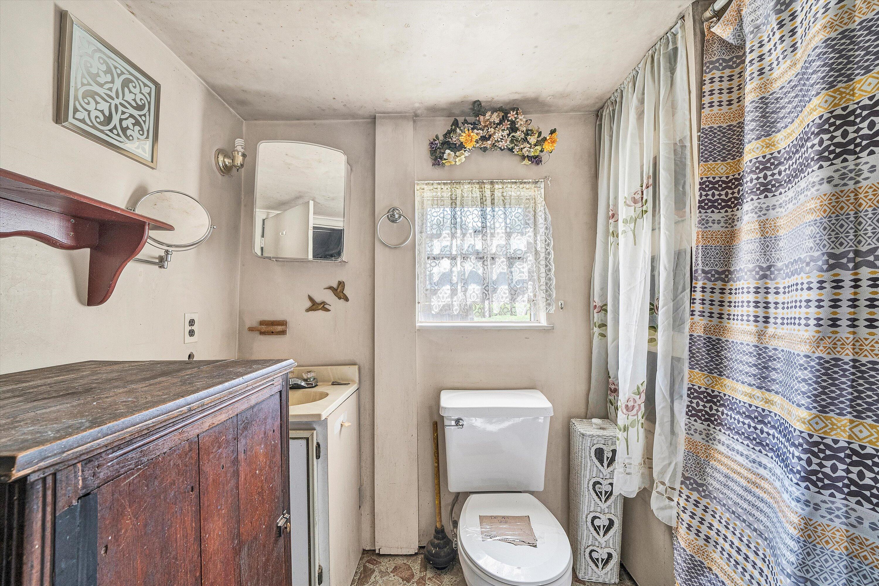 2816 Johns Creek Road New Castle, VA 24127 - Photo 21 of 40 a bathroom with a granite countertop toilet sink and mirror