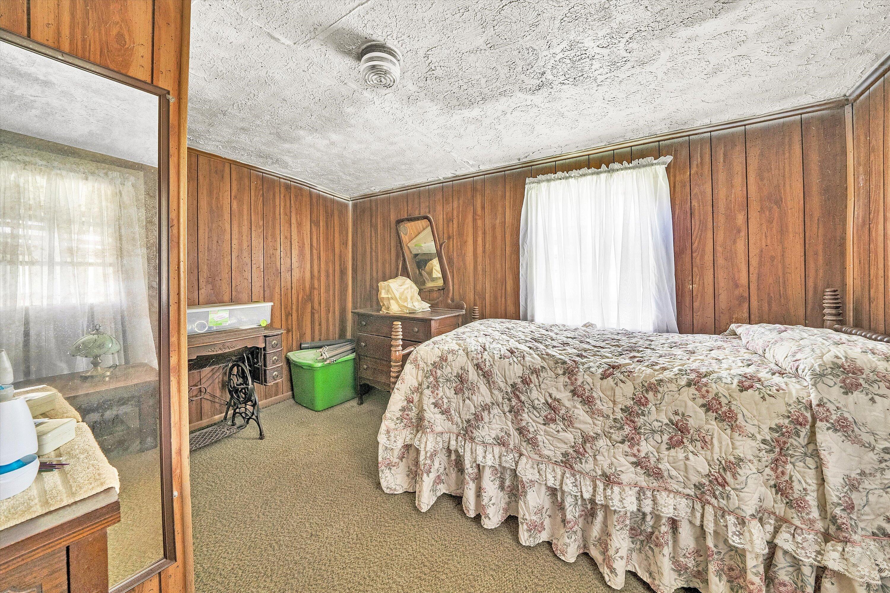 2816 Johns Creek Road New Castle, VA 24127 - Photo 27 of 40 a bedroom with a bed mirror and window