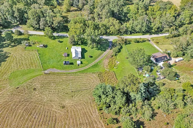 a view of a golf ground with large trees