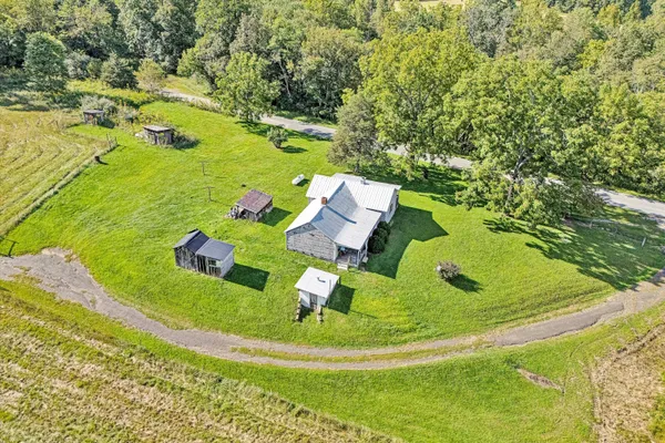 an aerial view of a house with garden space and a street view