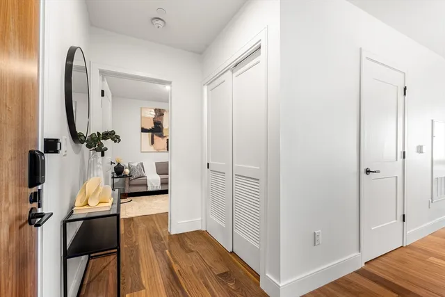 a view of a livingroom with wooden floor and furniture