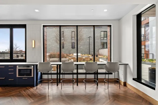 a living room with furniture and large window