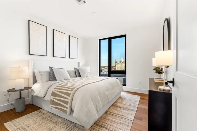 a bedroom with double bed and a window