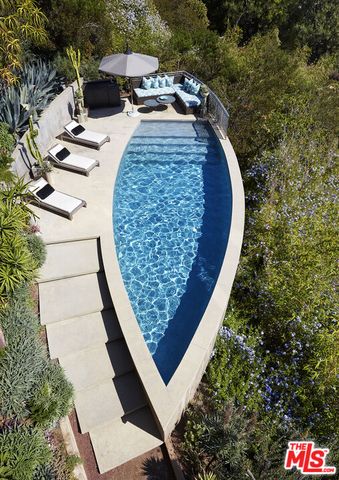 a view of a wooden floor with a bench in a backyard