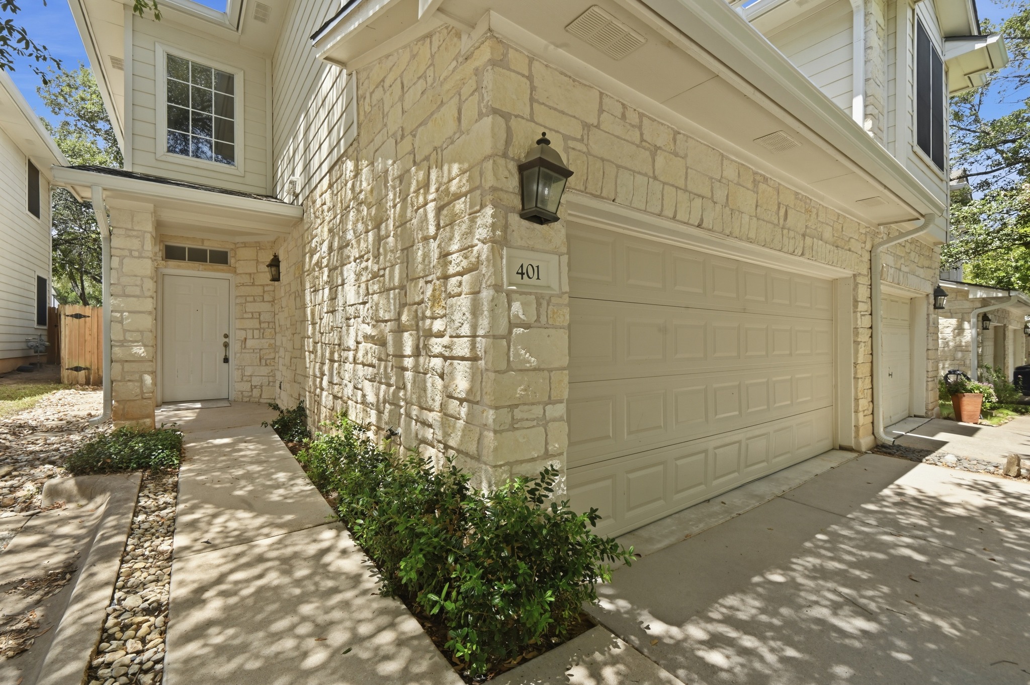 4508 Duval Road, Unit 4401 Austin, TX 78727 - Photo 4 of 26 Textured stone siding and a neat concrete walkway welcome guests to the front entry.