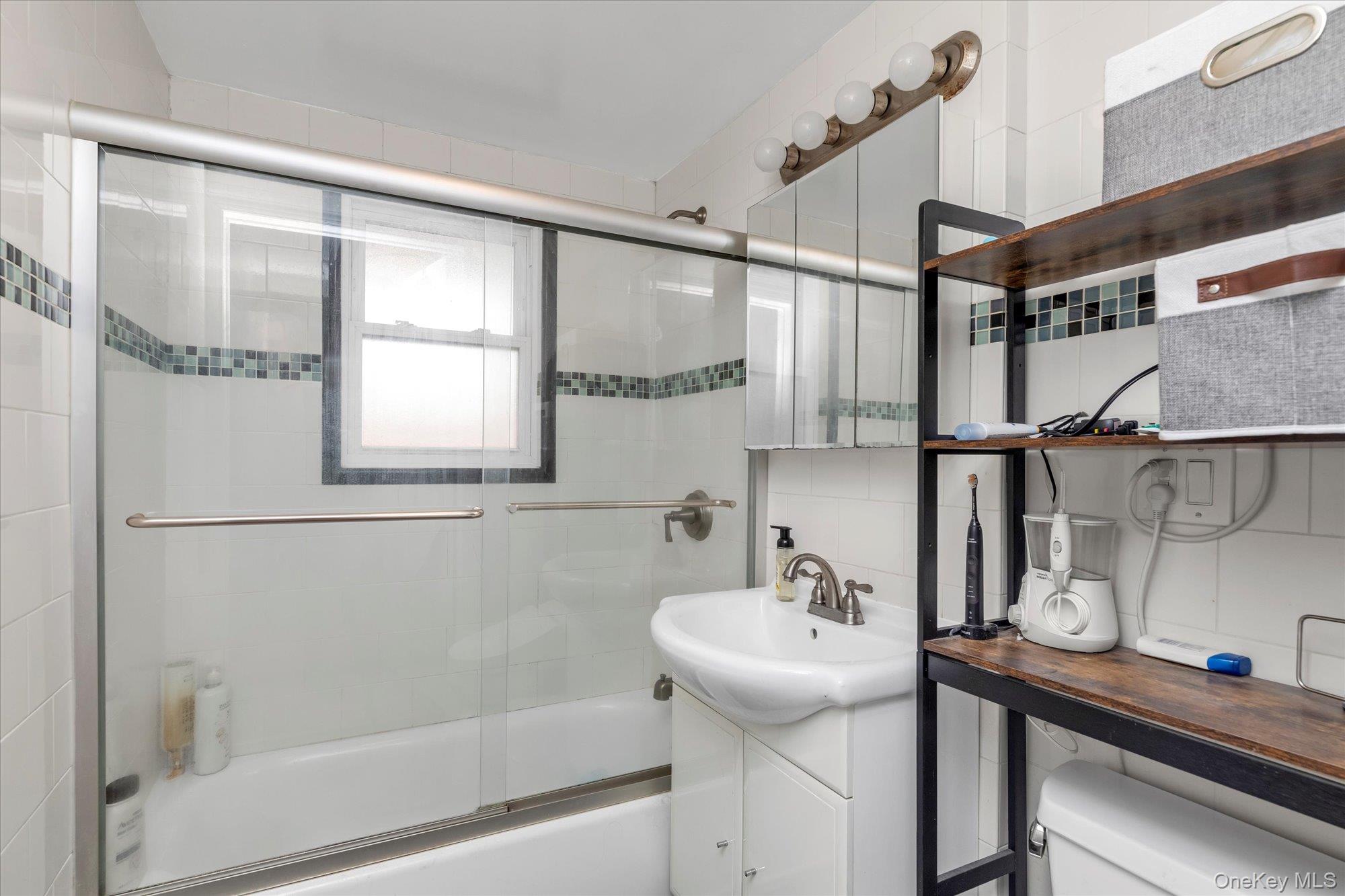40-38 194th Street, Unit A1 Queens, NY 11358 - Photo 12 of 18 a bathroom with a sink and a mirror