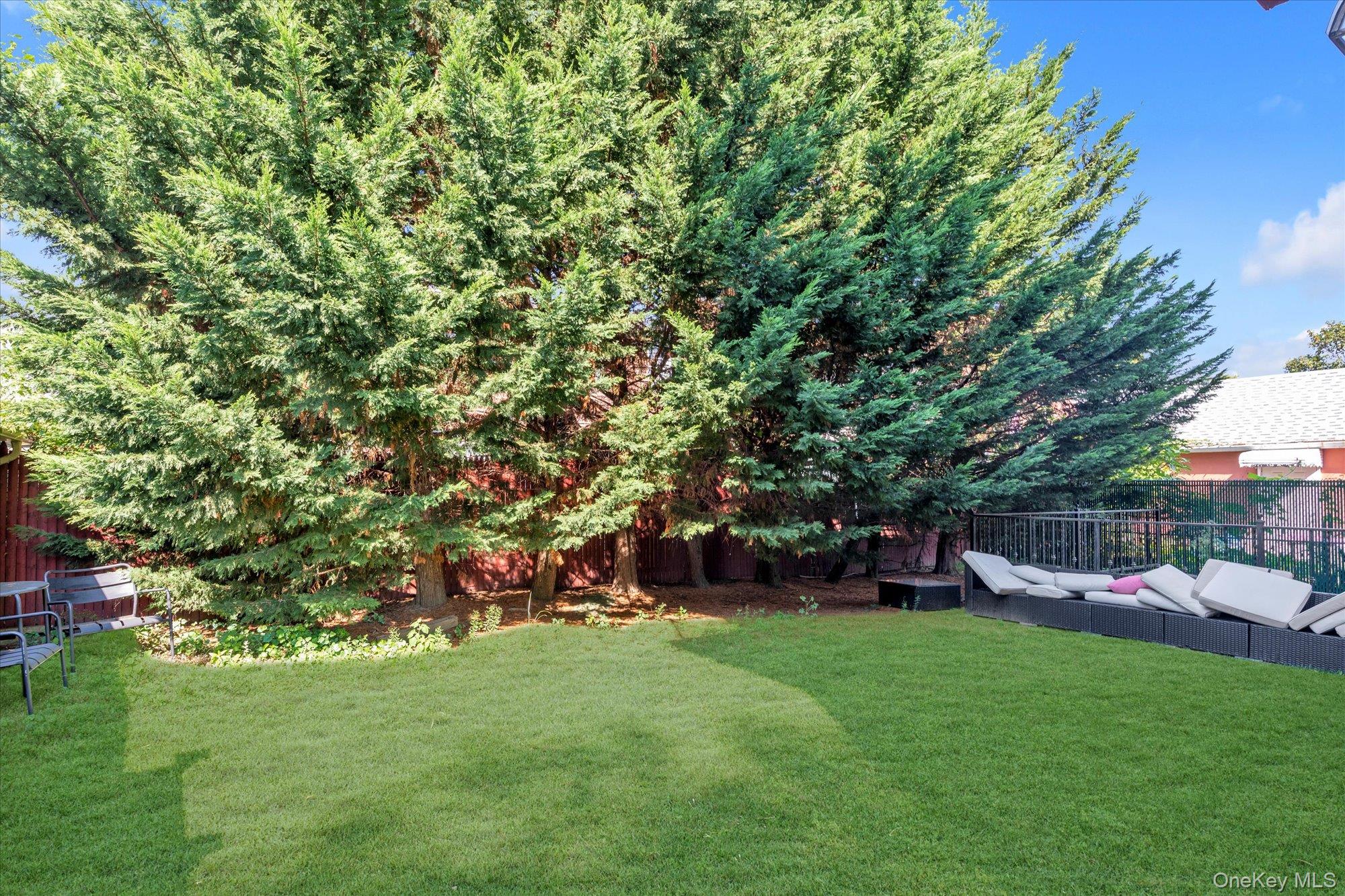 40-38 194th Street, Unit A1 Queens, NY 11358 - Photo 16 of 18 a view of yard with green space and porch
