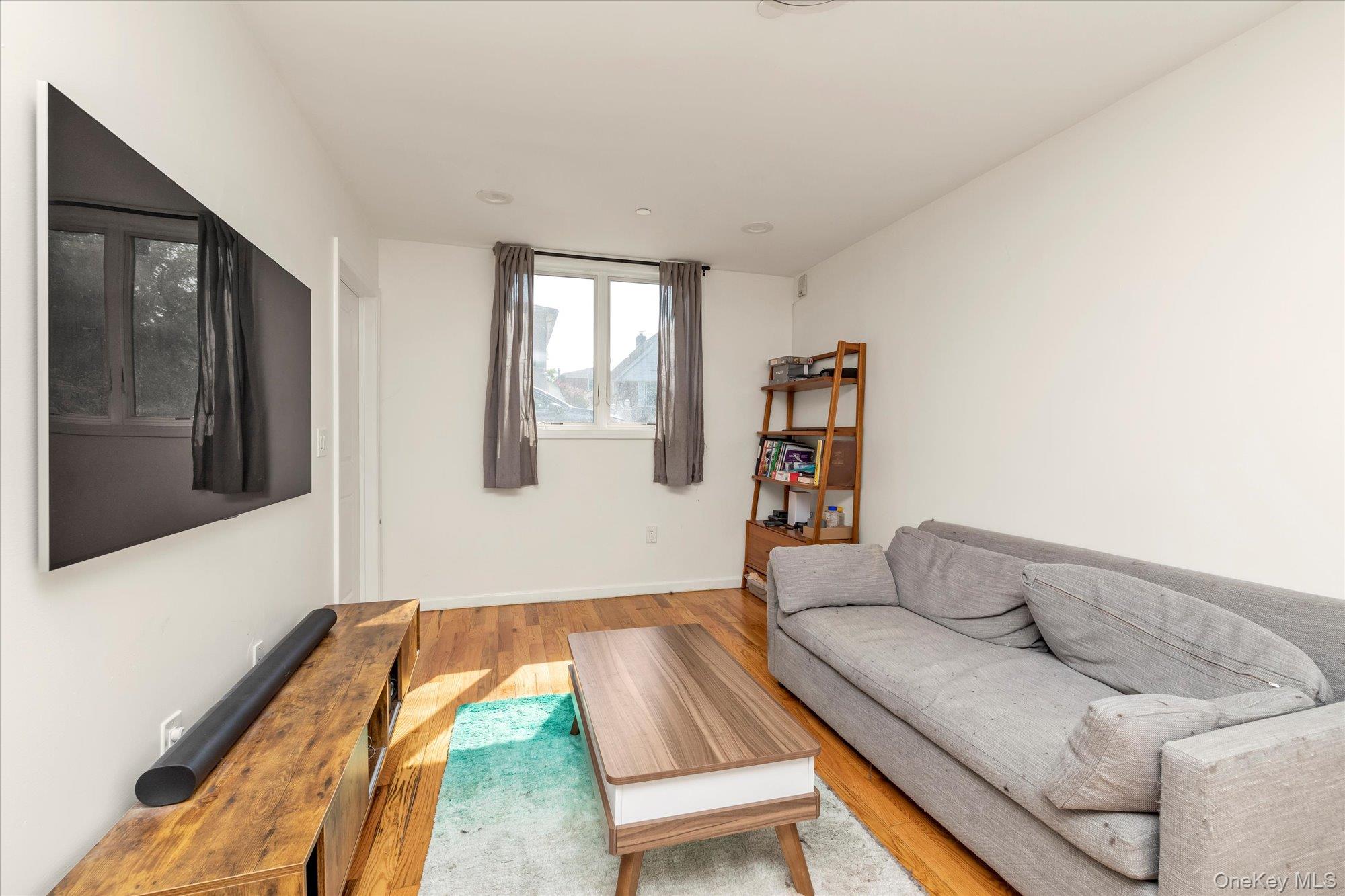 40-38 194th Street, Unit A1 Queens, NY 11358 - Photo 4 of 18 a living room with furniture and a window
