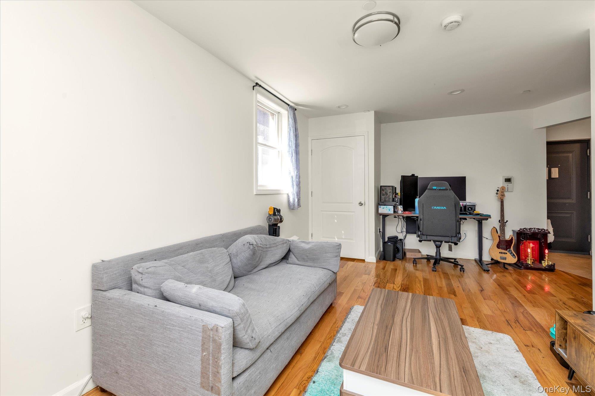 40-38 194th Street, Unit A1 Queens, NY 11358 - Photo 6 of 18 a living room with furniture and a flat screen tv