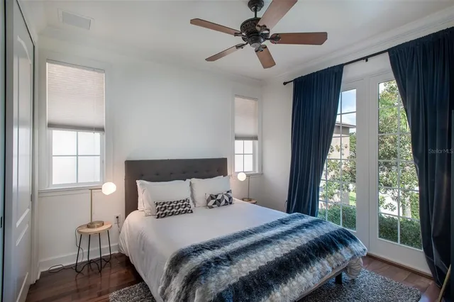 a bedroom with a large bed and a window