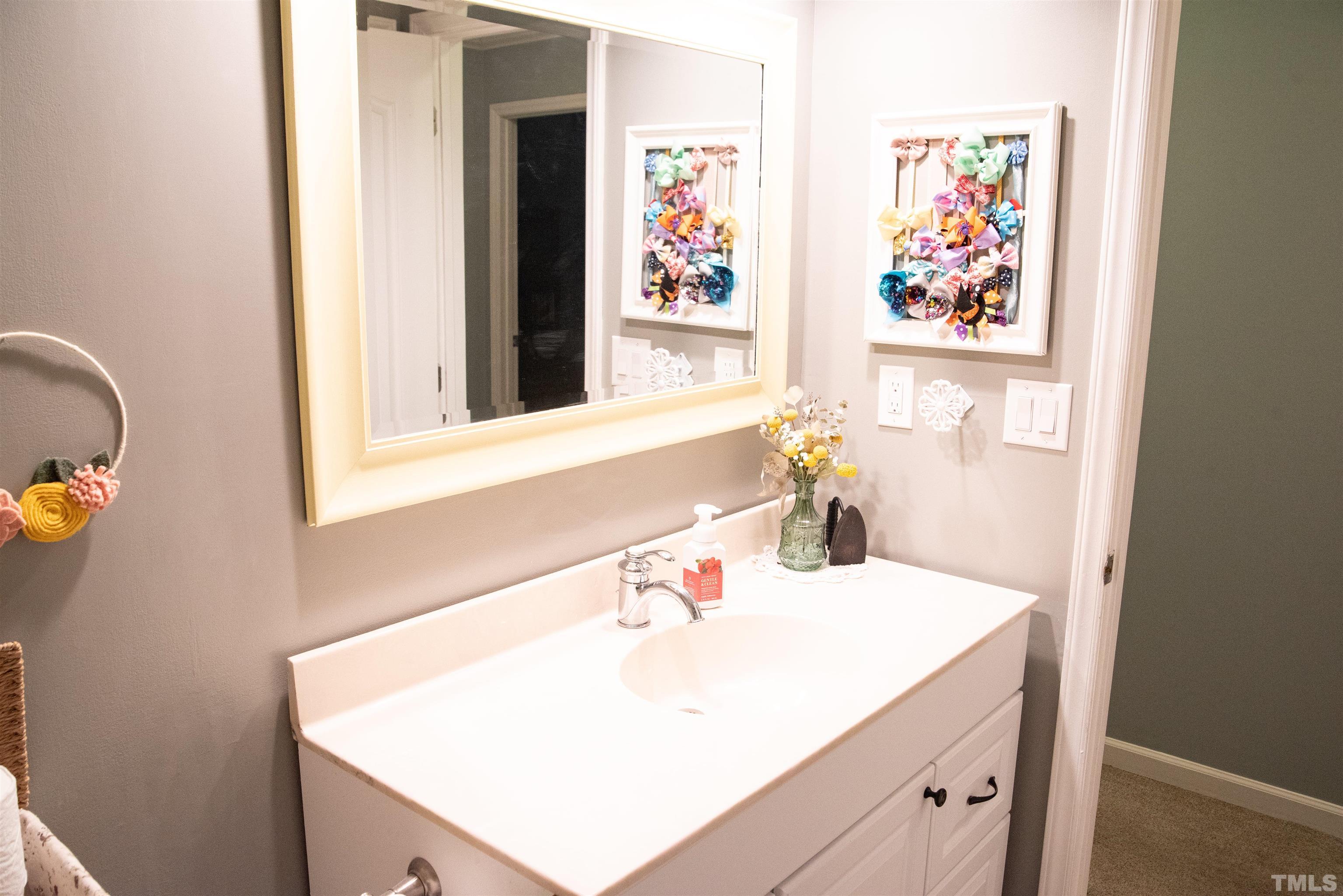 119 Joanne Circle Cary, NC 27513 - Photo 16 of 23 a bathroom with a sink and a mirror