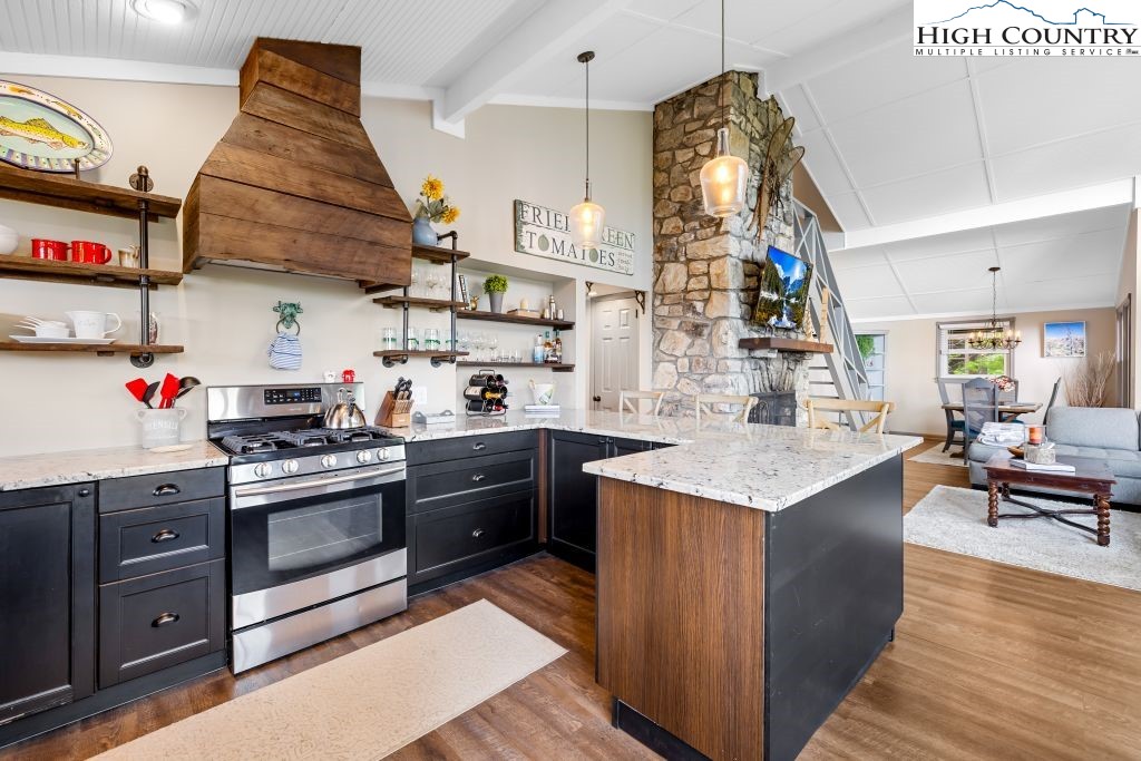 844 Pine Ridge Road Beech Mountain, NC 28604 - Photo 11 of 34 a kitchen with stainless steel appliances granite countertop a sink and a stove
