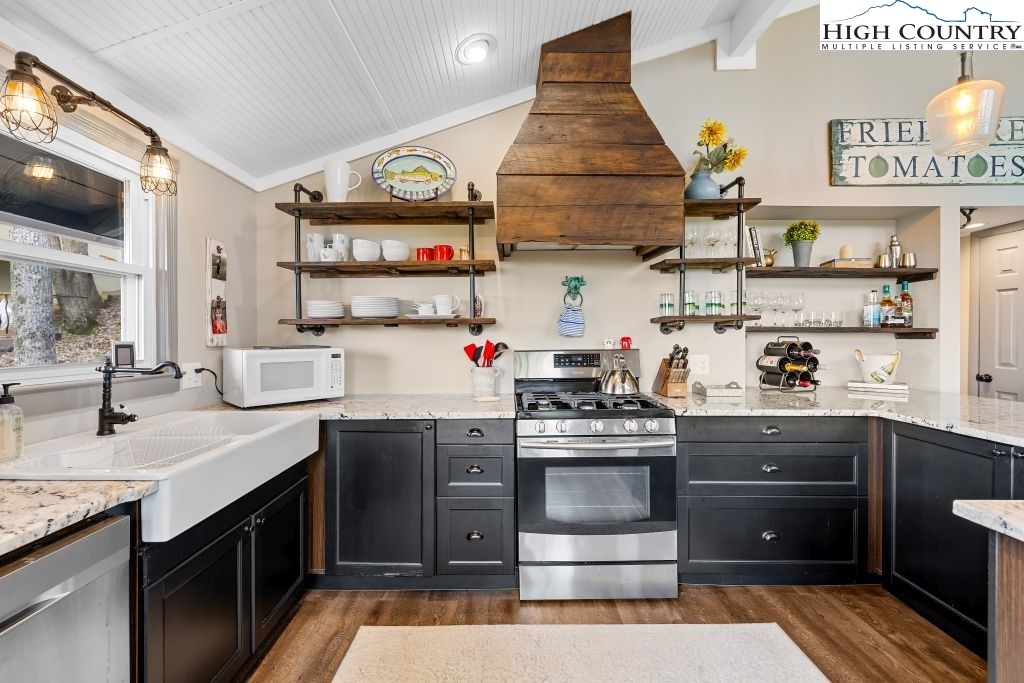 844 Pine Ridge Road Beech Mountain, NC 28604 - Photo 12 of 34 a kitchen with stainless steel appliances granite countertop a stove and cabinets