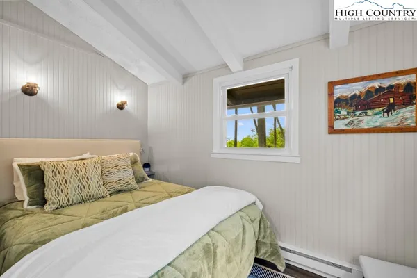 a bedroom with a bed and wall painting