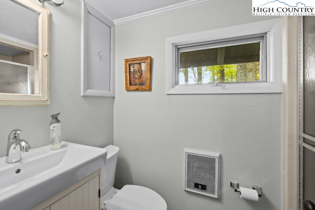 844 Pine Ridge Road Beech Mountain, NC 28604 - Photo 22 of 34 a bathroom with a toilet sink vanity and mirror