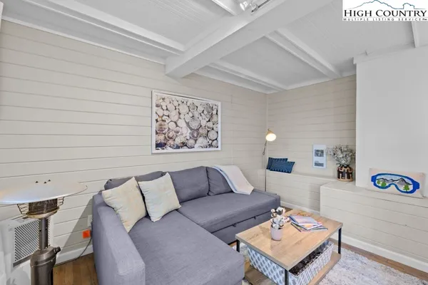 a living room with furniture and a wall painting