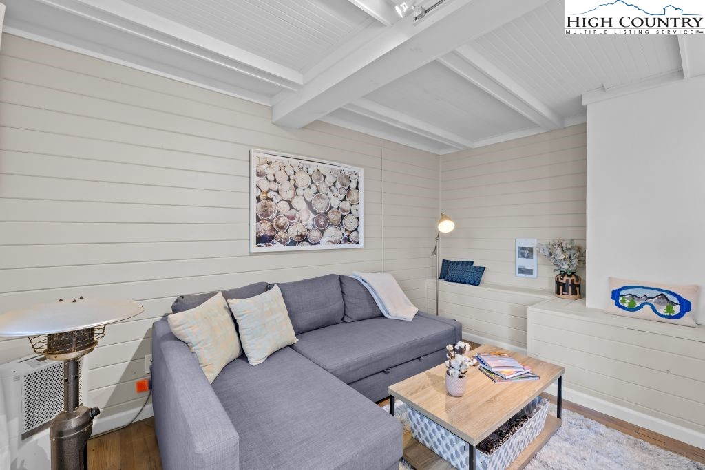 844 Pine Ridge Road Beech Mountain, NC 28604 - Photo 24 of 34 a living room with furniture and a wall painting