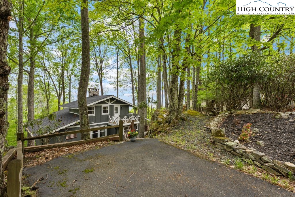 844 Pine Ridge Road Beech Mountain, NC 28604 - Photo 30 of 34 a wooden bench sitting in front of a building