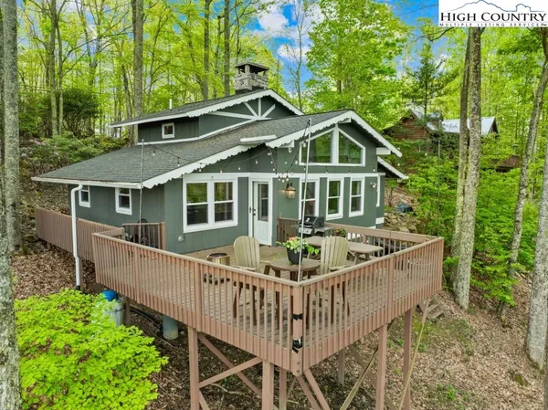 a front view of a house with a garden and deck