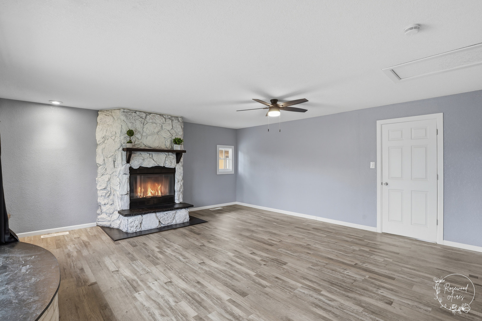 235 East 2740s Road Kankakee, IL 60901 - Photo 10 of 22 a view of an empty room with wooden floor fireplace and a window