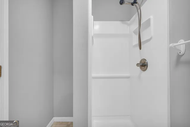 a view of empty room with wooden floor