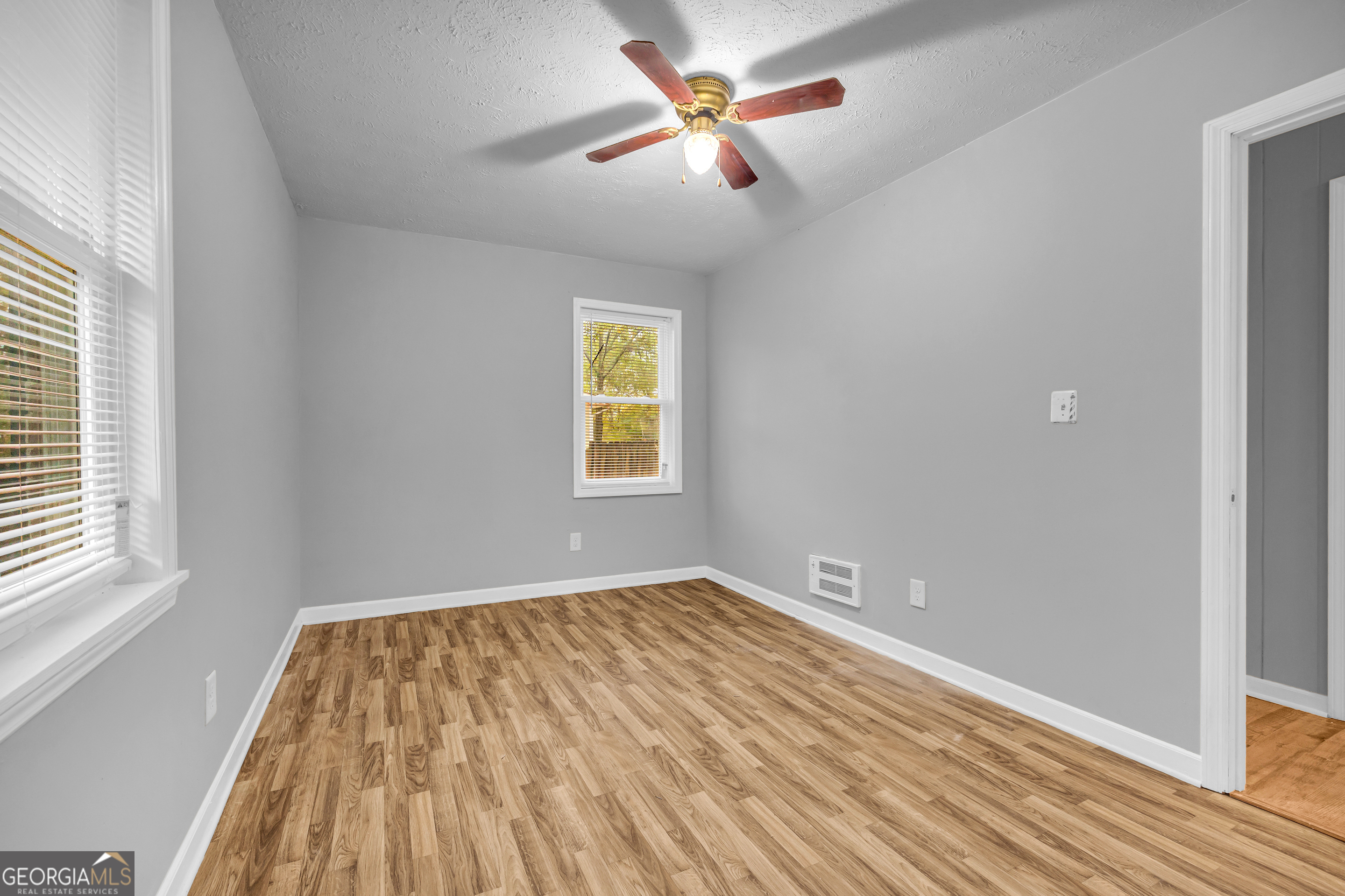 73 Highland Estates Commerce, GA 30529 - Photo 18 of 55 a view of empty room with wooden floor and fan