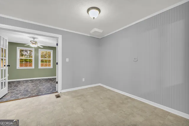 an empty room with closet and windows