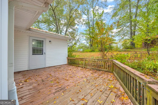 a view of a porch with wooden floor and outdoor space