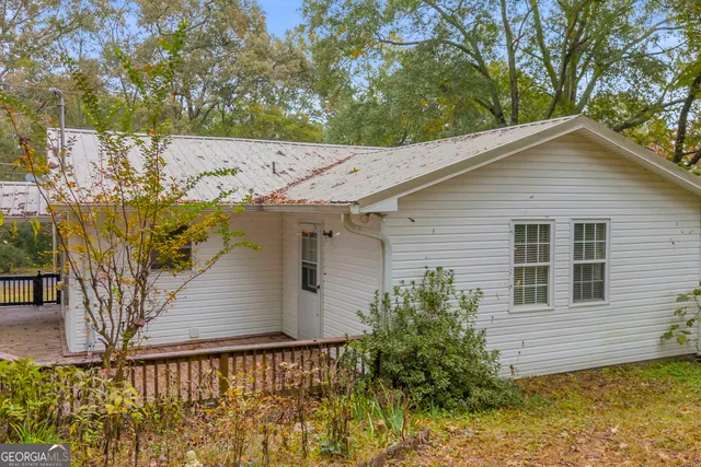 a house that has a tree in front of it