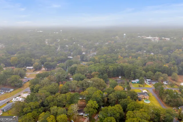 an aerial view of a houses with yard