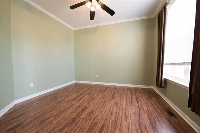 wooden floor in an empty room with a window