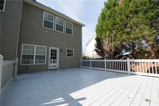 a view of backyard with deck and wooden floor