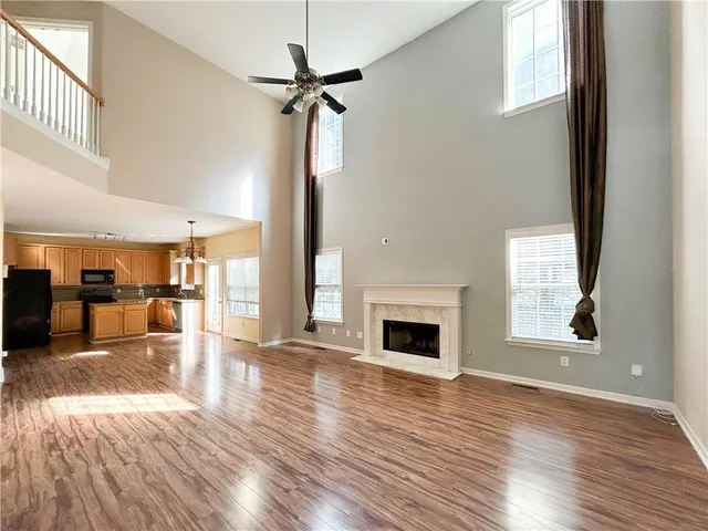 a view of empty room with wooden floor and fireplace