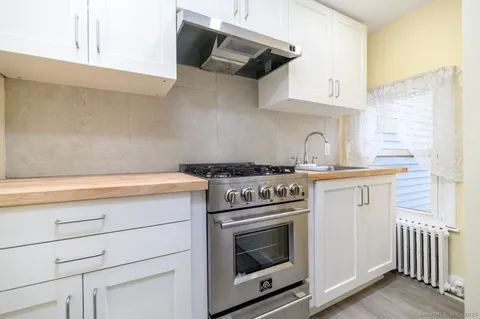 a kitchen with wooden cabinets and a stove top oven