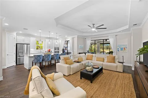 a living room with furniture ceiling fan and a rug